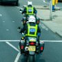 Scenes of London - two police motorcycles making their way through traffic