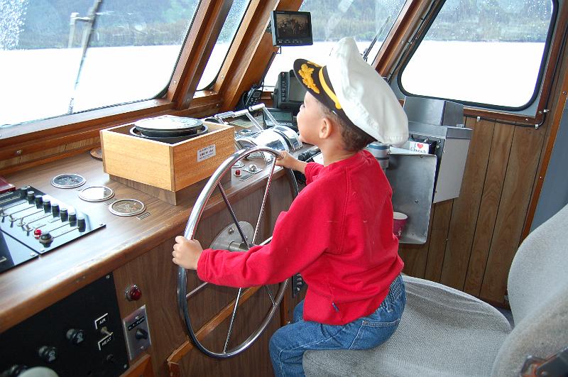 19.JPG - Captain Octavious at the helm of the tour boat