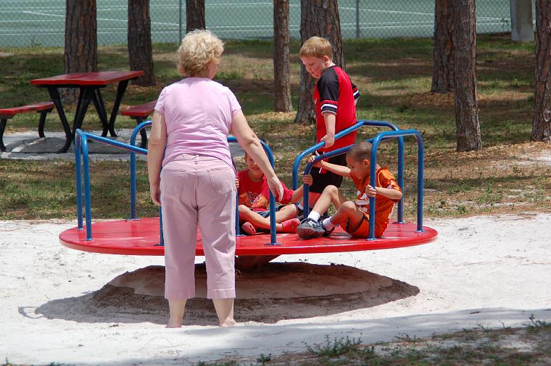 DSC_5114.JPG - Tavus, Matthew and Landon being pushed on the roundabout